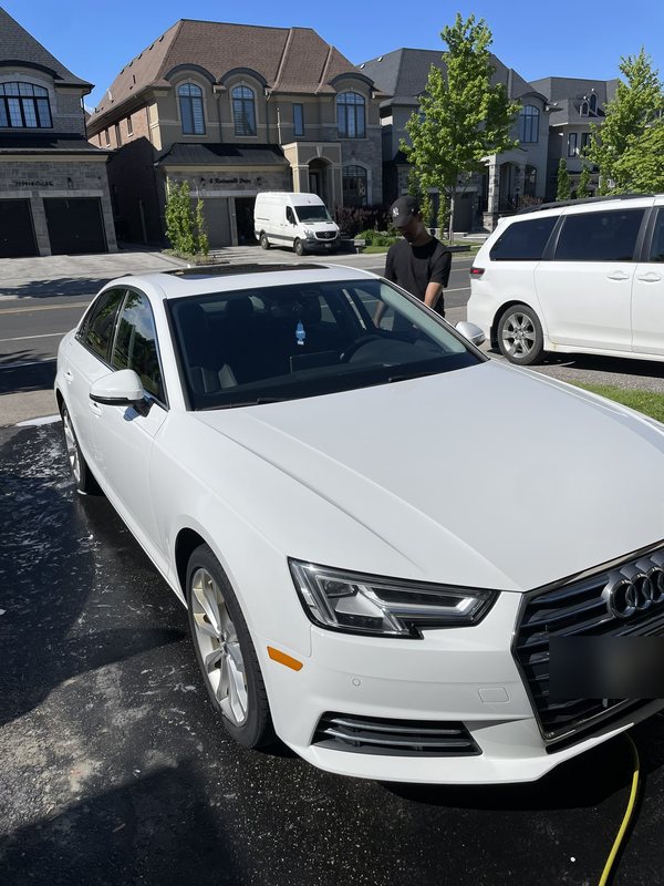 White Audi A4 detailed in a residential driveway